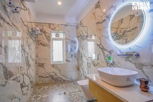 a bathroom with a sink and a mirror at StayVista at Pineview @ Albert Estate in Mussoorie