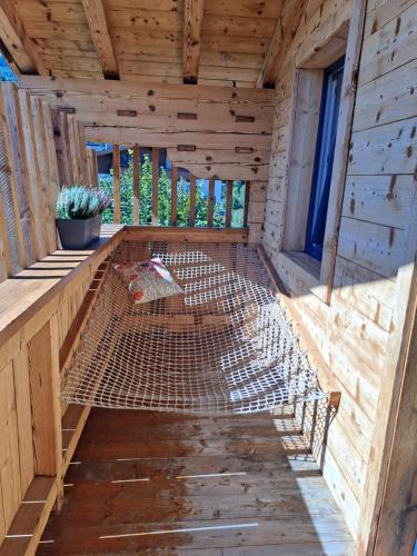 a wooden chicken coop with a bed in the inside at Erlenhof in Maria Alm am Steinernen Meer