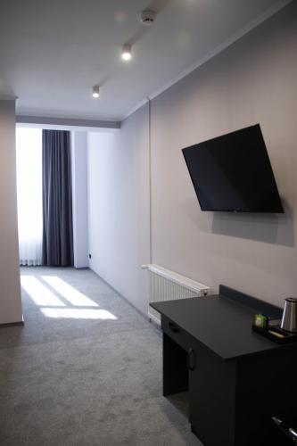 a room with a flat screen tv on a wall at GOLDEN RING in Ternopilʼ