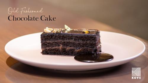a piece of chocolate cake on a plate on a table at IKON By Annapoorna in Coimbatore