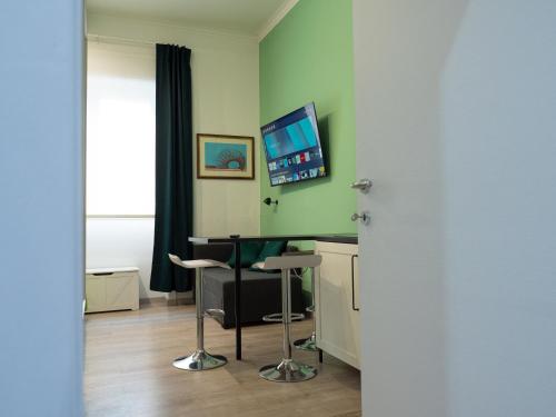 a room with a desk and two stools at Porta Vittoria Residence in Milan