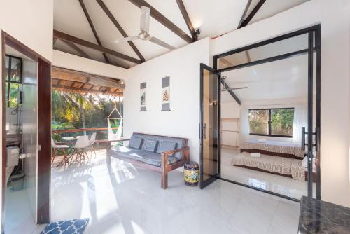 an open living room with a sliding glass door at Casa Bianca Siargao in General Luna