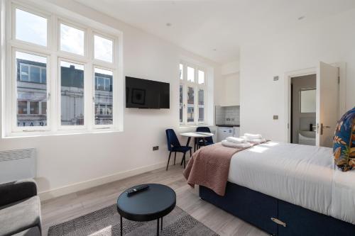 a bedroom with a bed and a table and chairs at Richmond by Capital in London