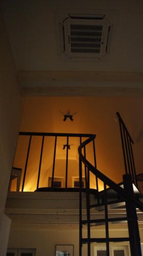 a view from the top of a balcony with a plane flying overheard at Apartamenty Street 18 in Toruń