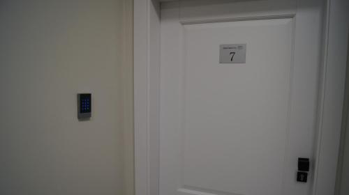 a door with a clock on it in a room at Apartamenty Street 18 in Toruń