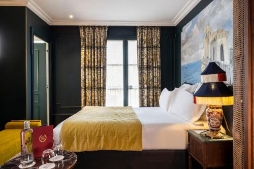a hotel room with a bed and a window at Hôtel Monte Cristo in Paris