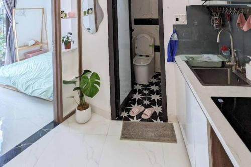 a bathroom with a toilet and a sink and a counter at Cozy apartment w/ 2 private BR & free bike parking in Hanoi