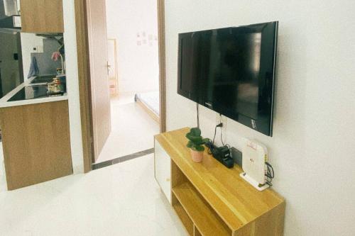 a living room with a flat screen tv on a wall at Cozy apartment w/ 2 private BR & free bike parking in Hanoi