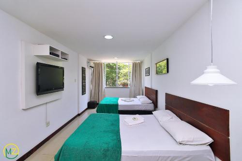 A bed or beds in a room at Studio reformado para 5 pessoas em Copacabana