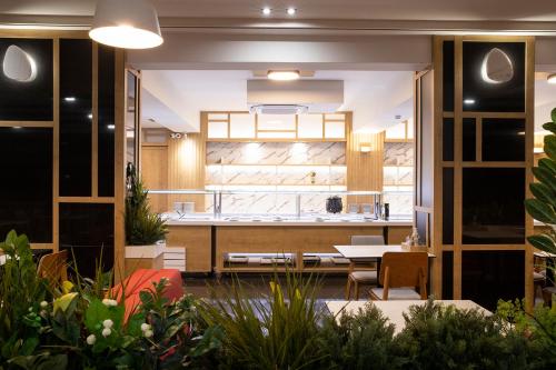 a kitchen and dining room with a table and chairs at Dafni Plus Hotel in Leptokaria