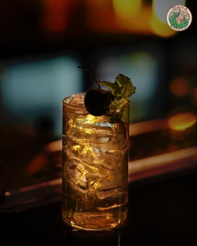 a drink with a black olive on top at Hotel Pearl Palace Jaipur in Jaipur