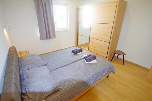 a bedroom with a bed with two towels on it at Holiday house with private pool in village Šišan in Šišan