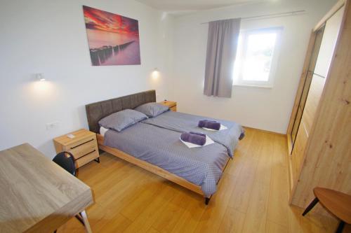 a bedroom with a bed with purple pillows on it at Holiday house with private pool in village Šišan in Šišan