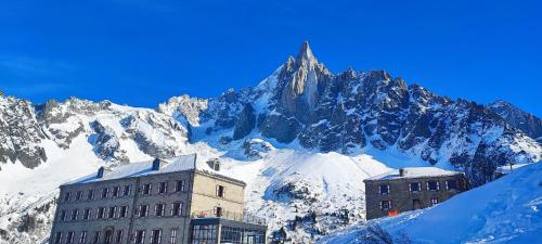 a building in front of a snow covered mountain at Refuge du Montenvers in Chamonix-Mont-Blanc