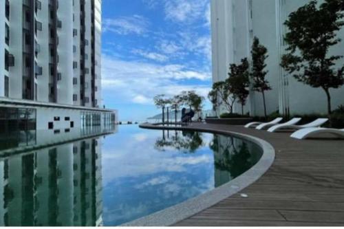 a reflection of a building in a body of water at THE SHORE KK CITY VIEW S15 By BC 亚比城市景观 in Kota Kinabalu