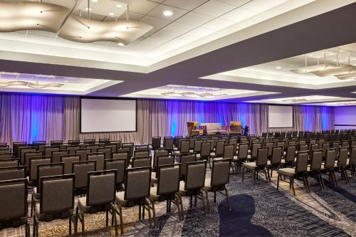 a conference room with rows of chairs and a podium at Sheraton Phoenix Downtown in Phoenix