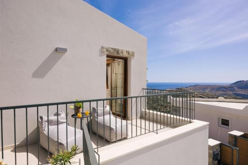 a balcony with a view of the ocean at Mirthea Suites in Mírthios