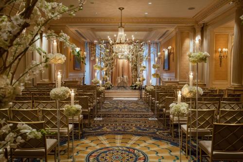 a wedding hall with chairs and a chandelier at JW Marriott Essex House New York in New York