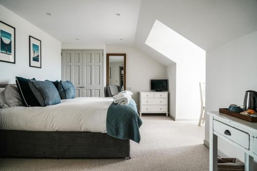 a bedroom with a large bed and a dresser at Macdonald's Farm in Saint Ervan