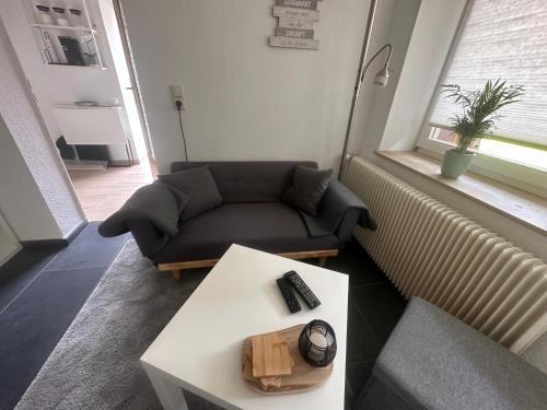 a living room with a couch and a coffee table at Sauerlandapartment Emely in Plettenberg