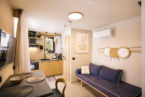 a living room with a couch and a table at Mirthea Suites in Mírthios