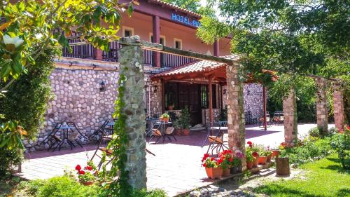 a courtyard of a building with plants and flowers at Pineas in Kalabaka