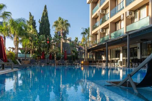 a large swimming pool in front of a hotel at Laren Family Hotel & Spa - Boutique Class in Antalya