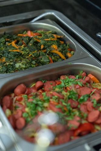 two metal trays filled with different types of food at Laren Family Hotel & Spa - Boutique Class in Antalya