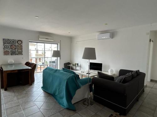 a living room with a couch and a table at Tavira near the center - two bedroom with balcony in Tavira