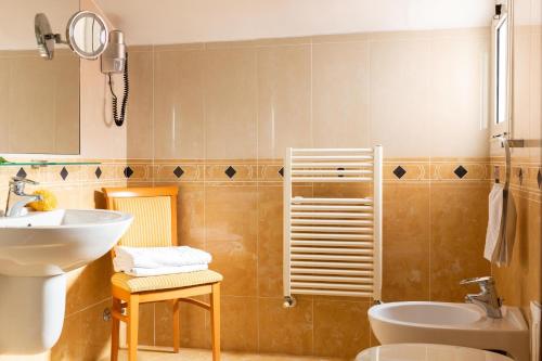 a bathroom with a sink and a toilet at Hotel & Residence Venezia 2000 in Venice-Lido