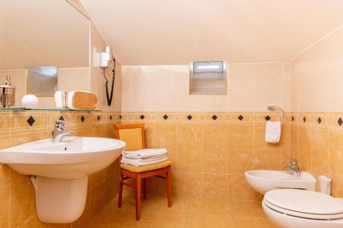 a bathroom with a sink and a toilet at Hotel & Residence Venezia 2000 in Venice-Lido