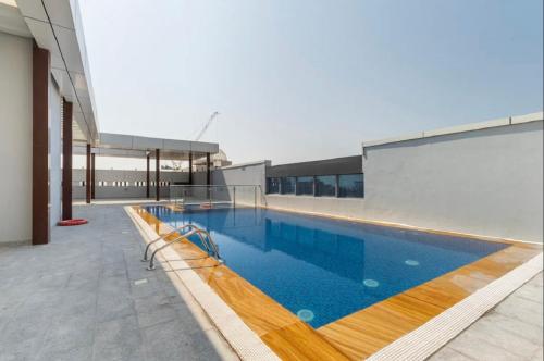 a swimming pool on the roof of a building at Private Room in Bright & Cozy Apt Near Downtown, Near Metro, Pool, Gym in Dubai