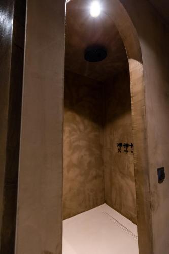 a walk in shower in a room with a ceiling at Life Gallery Hotel & Spa in Korçë