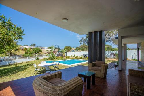 a house with a view of a swimming pool at Ponta d’ ouro lia’s house in Ponta do Ouro