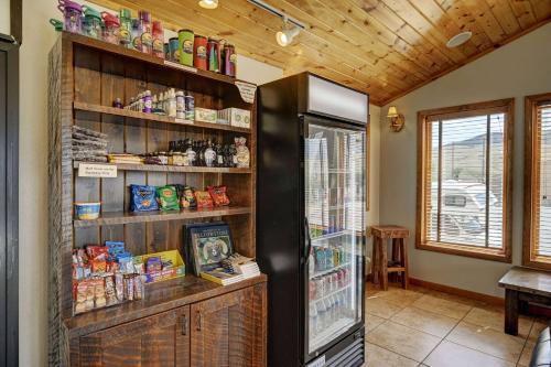 a room with a refrigerator in a room with a table at Super 8 by Wyndham Gardiner/Yellowstone Park Area in Gardiner