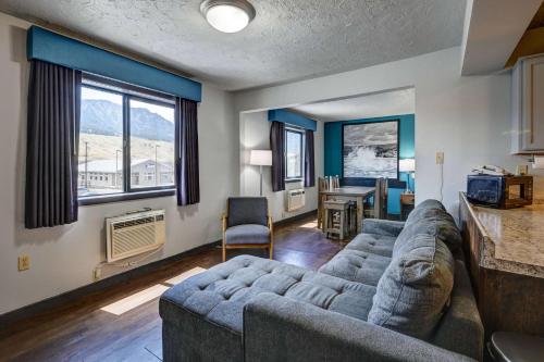 a living room with a couch and a table at Super 8 by Wyndham Gardiner/Yellowstone Park Area in Gardiner