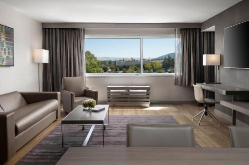 a living room with a couch and a table at AC Hotel by Marriott Pleasanton in Pleasanton