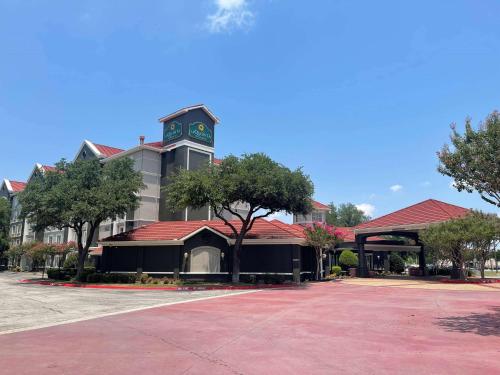 a building with a clock tower on top of it at La Quinta by Wyndham Dallas Arlington South in Arlington