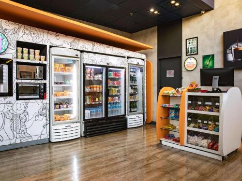a grocery store with two refrigerators in a room at ibis budget Sao Paulo Paraiso in Sao Paulo