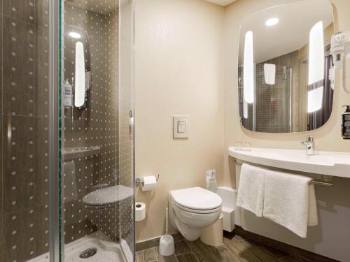 a bathroom with a toilet and a sink and a shower at ibis Kyiv Railway Station in Kyiv