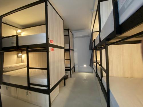 a room with several bunk beds in it at We Street Hostel - Albergue in El Arenal