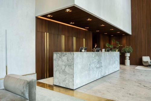 a lobby with a reception desk in a building at Hilton Garden Inn Tbilisi Chavchavadze in Tbilisi City