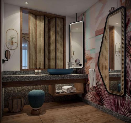 W łazience znajduje się umywalka i lustro. w obiekcie Canopy By Hilton Seychelles w mieście Anse a La Mouche