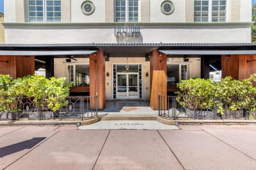 a building with wooden pillars in front of it at La Flora by LuxUrban Trademark Collection by Wyndham in Miami Beach