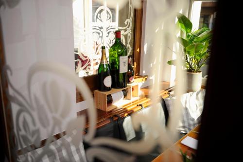 two bottles of wine on a shelf in a room at Hotel Stoller in Zürich