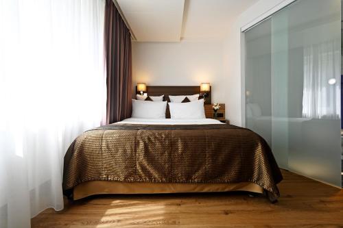 a bedroom with a large bed with white pillows at Hotel Stoller in Zürich