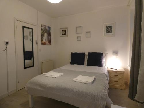 a bedroom with a bed with two towels on it at Angus Studios for Bike Park Wales and Brecons in Merthyr Tydfil