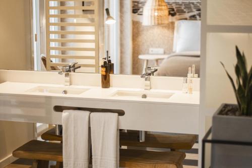 a bathroom with a white sink and a mirror at room Select Liberdade in Lisbon