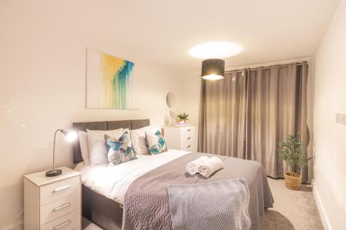 a bedroom with a bed and a lamp and curtains at New 1 Bed 1 Bath Apartment in Cool Digbeth in Birmingham