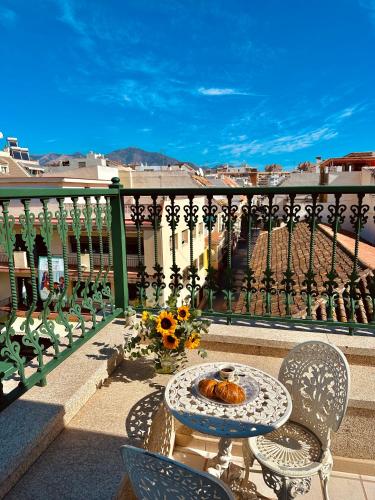 a table and chairs on a balcony with a view at Hotel Reyesol in Fuengirola